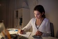 Woman with calculator and papers at night office Royalty Free Stock Photo