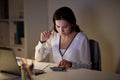 Woman with calculator and papers at night office Royalty Free Stock Photo