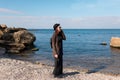 Woman calling by cell phone and walking on beach. Royalty Free Stock Photo