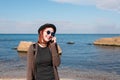 Woman calling by cell phone and walking on beach. Royalty Free Stock Photo