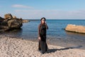 Woman calling by cell phone and walking on beach. Royalty Free Stock Photo