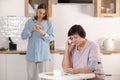 worried young woman calling doctor for her senior mother at home. sick senior woman with medication sitting at the table Royalty Free Stock Photo
