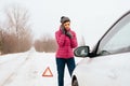 Woman calling for help or assistance - winter car breakdown Royalty Free Stock Photo