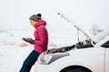 Woman calling for help or assistance - winter car breakdown Royalty Free Stock Photo