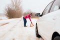 Woman calling for help or assistance - winter car breakdown Royalty Free Stock Photo