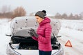 Woman calling for help or assistance - winter car breakdown Royalty Free Stock Photo