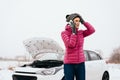 Woman calling for help or assistance - winter car breakdown Royalty Free Stock Photo