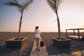 Woman calling by phone and walking on beach. Royalty Free Stock Photo