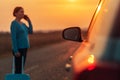 Woman calling roadside assistance after her car broke down