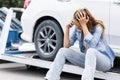 Woman calling at roadside car broken for need help while towing service assistance moving her car out Royalty Free Stock Photo