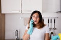 Woman Calling To Plumber For Water Leakage Problem Royalty Free Stock Photo