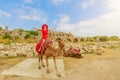 Woman on camel in Side archaeological site Turkey