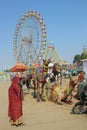 Woman camels and ferris wheels at Pushkar camel fair Royalty Free Stock Photo