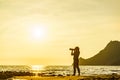 Woman with camera on Monsul beach, Spain