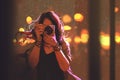 Woman with camera on night city background Royalty Free Stock Photo