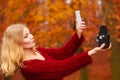 Woman with camera and smartphone take selfie photo Royalty Free Stock Photo