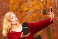 Woman with camera and smartphone take selfie photo Royalty Free Stock Photo