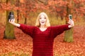 Woman with camera and smartphone take selfie photo Royalty Free Stock Photo