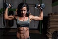 Woman in camouflage outfit working out in a gym