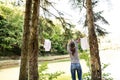 Woman on camping holiday in forest at the lake.