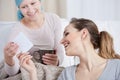 Woman with cancer and her friend looking at photograph Royalty Free Stock Photo