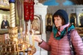 Woman with candle in Holy Cross Church in Livadia