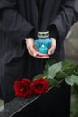 Woman with candle outdoors, focus on roses. Funeral ceremony Royalty Free Stock Photo