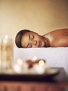 Woman, candles or wax light at a spa for massage, healing or luxury treatment therapy. Female person, wellness or Royalty Free Stock Photo