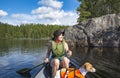 Woman canoeing on the lake with dog Royalty Free Stock Photo