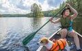 Woman canoeing on the lake with dog Royalty Free Stock Photo