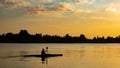 Woman canoeing at sunset on Vistula river, Poland. Royalty Free Stock Photo
