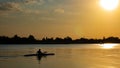 Woman canoeing at sunset on Vistula river, Poland. Royalty Free Stock Photo