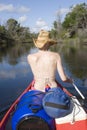 Woman canoing from behind portrait Royalty Free Stock Photo