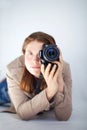 A woman with a canon DSLR camera prepares to take a photo