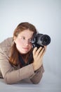 A woman with a canon DSLR camera prepares to take a photo