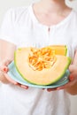 Woman with cantaloupe melon