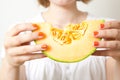 Woman with cantaloupe melon