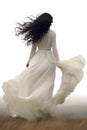 pretty young woman with long white dress blowing in the wind. long black hair. transparent PNG file.