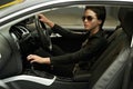 Woman, car and cool style while driving for a roadtrip adventure in a luxury vehicle. Female person, sunglasses and Royalty Free Stock Photo