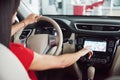 Woman in car indoor keeps wheel turning around smiling looking at passengers in back seat idea taxi driver against Royalty Free Stock Photo