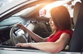 Woman in car indoor keeps wheel turning around smiling looking at passengers in back seat idea taxi driver against Royalty Free Stock Photo