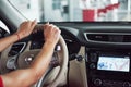 Woman in car indoor keeps wheel turning around smiling looking at passengers in back seat idea taxi driver against Royalty Free Stock Photo