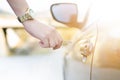 Woman with car key. Opening car door. WomanÃÂ´s hand unlocking a door on a car. Sunlight. Transportation. Royalty Free Stock Photo