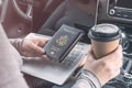 Woman in the car with laptop and american passport. Travel concept. Royalty Free Stock Photo