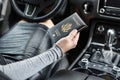 Woman in the car with laptop and american passport. Travel concept. Royalty Free Stock Photo