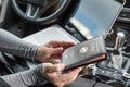 Woman in the car with laptop and germany passport. Travel concept. Royalty Free Stock Photo