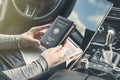 Woman in the car with laptop and germany passport. Travel concept. Royalty Free Stock Photo