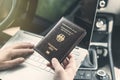 Woman in the car with laptop and germany passport. Travel concept. Royalty Free Stock Photo