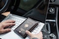 Woman in the car with laptop and germany passport. Travel concept. Royalty Free Stock Photo