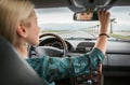 Woman in car look in rear view mirror Royalty Free Stock Photo